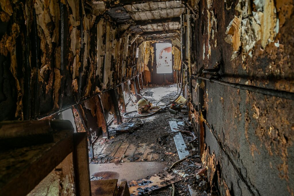 pexels-photo-1460264-1460264 Explore the eerie decay and rust of an abandoned hallway with peeling walls.