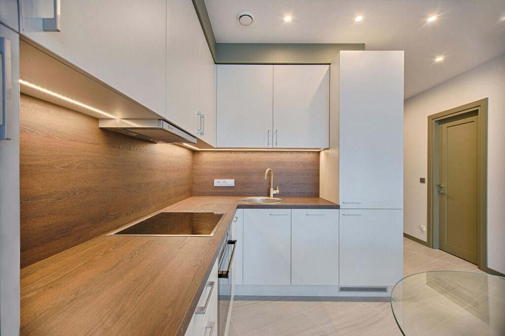 pexels-photo-1643384-1643384 Modern kitchen interior with minimalistic design and wooden accents, captured with natural lighting.