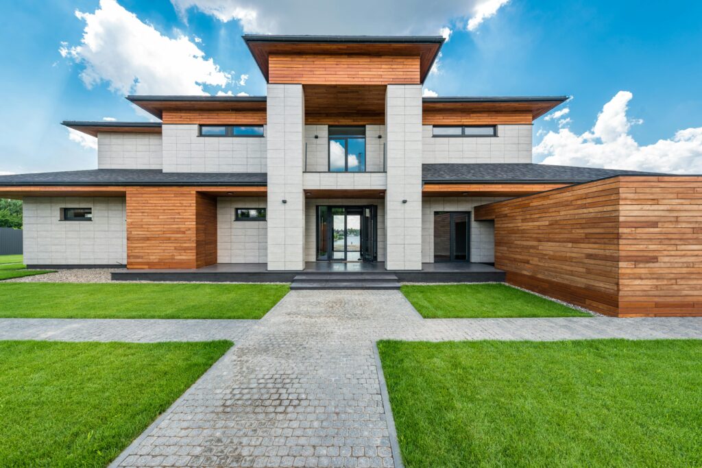 pexels-photo-7031595-7031595 Stunning contemporary house with wood and stone facade set against a vibrant blue sky.