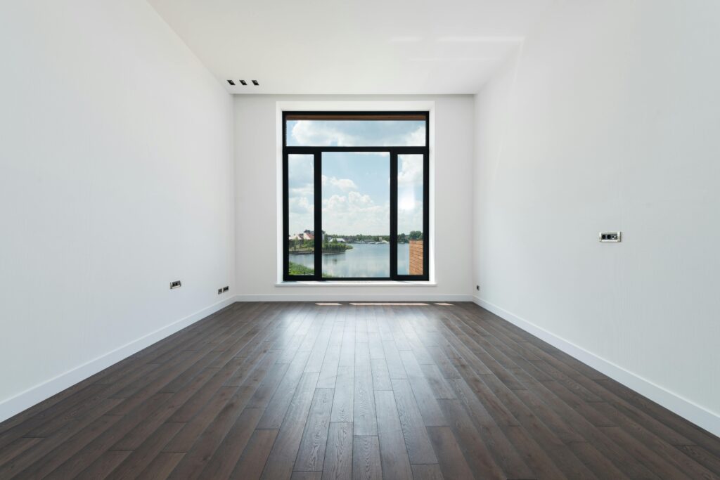 pexels-photo-7031616-7031616 Interior of modern spacious light room with wooden laminate floor white walls and panoramic windows