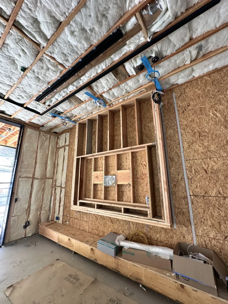 Insulated ceiling with lighting rough-ins and a framed wall recess during Southern California custom home construction