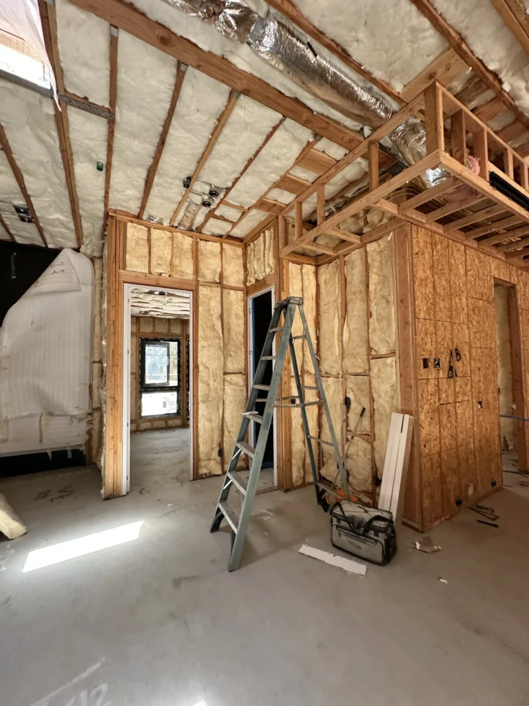 Insulated interior framing with HVAC ductwork and lighting rough-ins during Southern California custom home construction