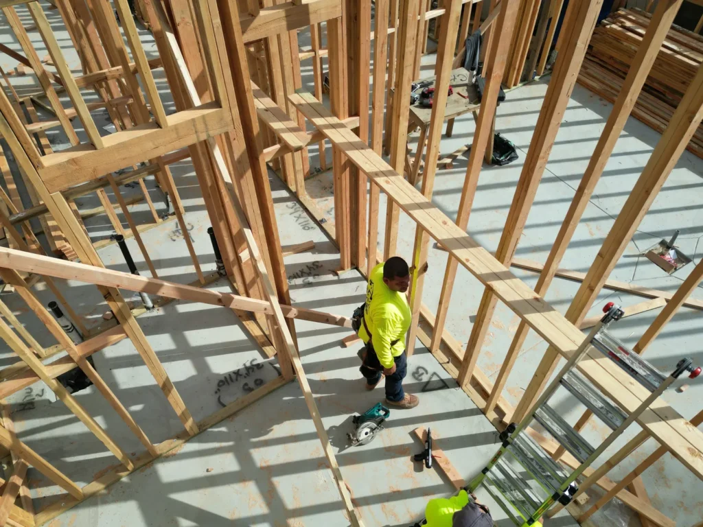 Crew working within the open wall framing.