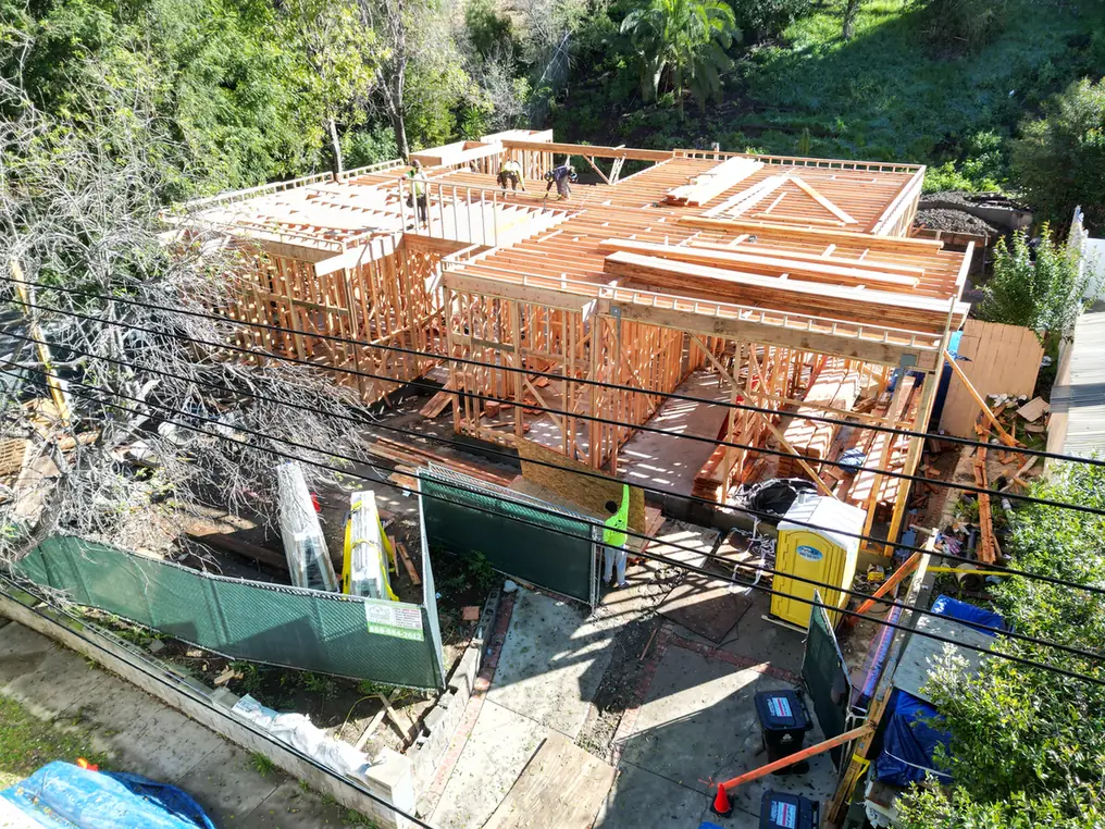 Custom Home Builders Los Angeles 17 Front view of wall and roof framing in progress.