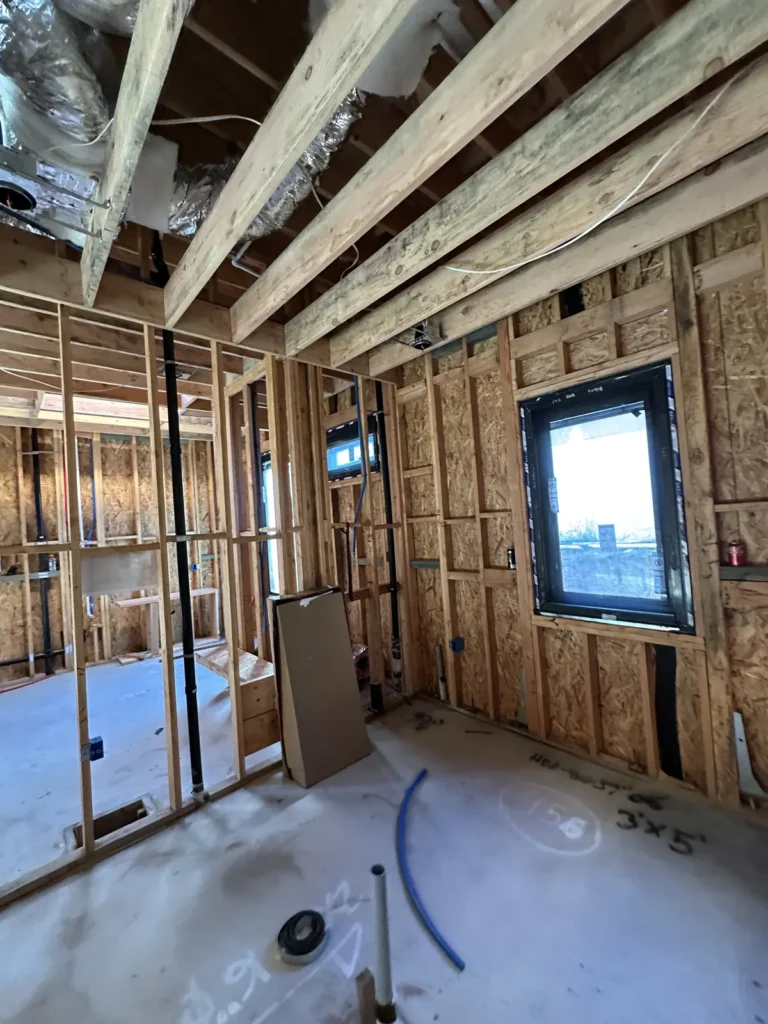 Plumbing rough-in within framed interior walls.