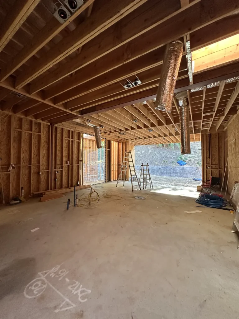 Open great-room framing with visible ceiling duct routes.