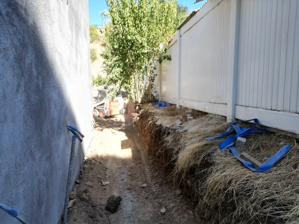 Narrow side access area during excavation work.