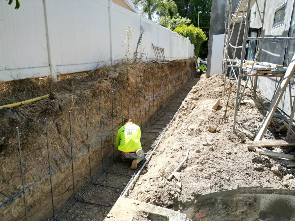 Side trench with reinforcement visible during construction.