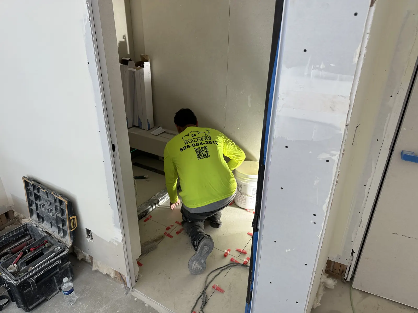 Custom Home Builders Los Angeles 27 Tile installation in progress at an interior doorway.