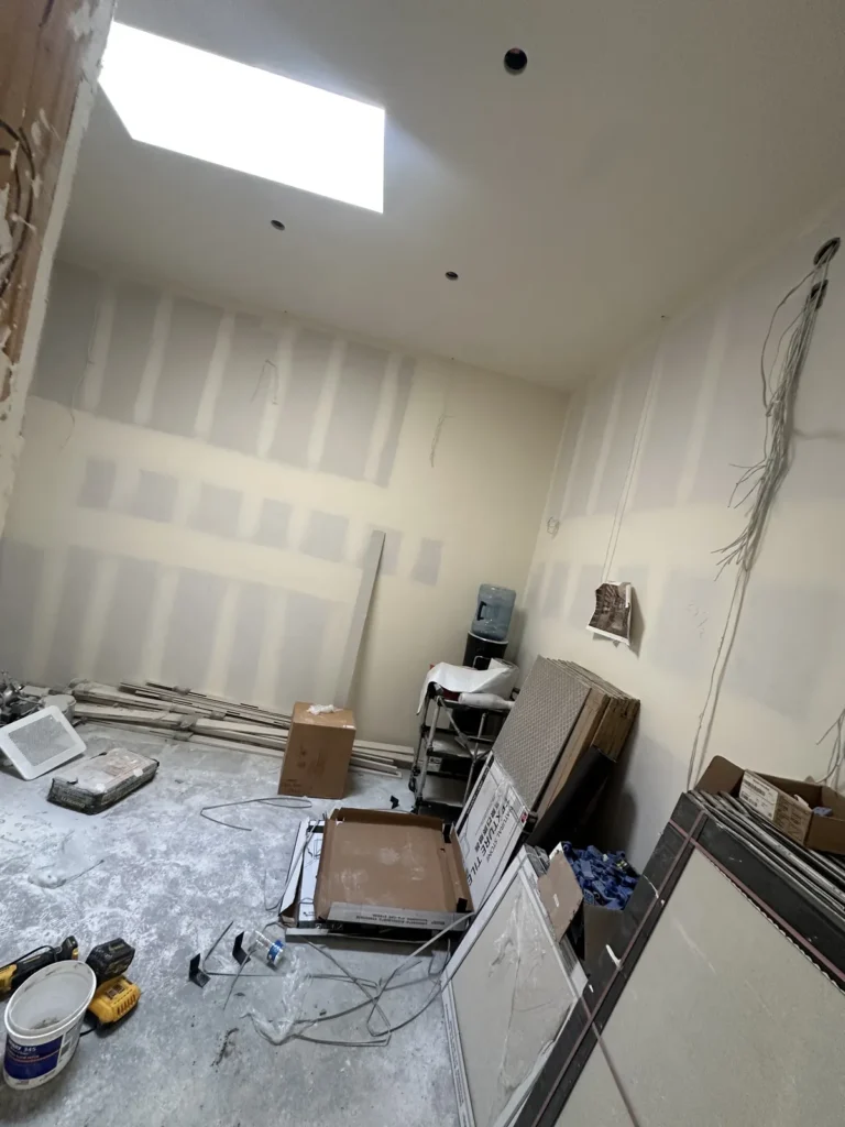 Bathroom ceiling and skylight area during drywall work.