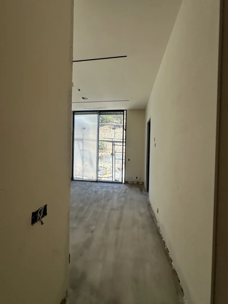 Hallway with drywall work in progress.