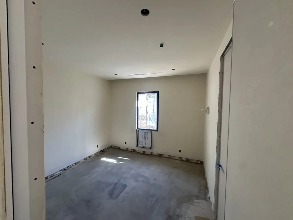 Interior room with unfinished drywall surfaces.