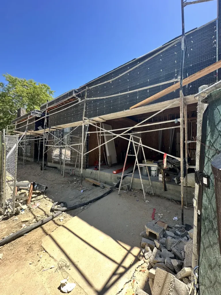 Exterior building wrap and scaffolding during construction.