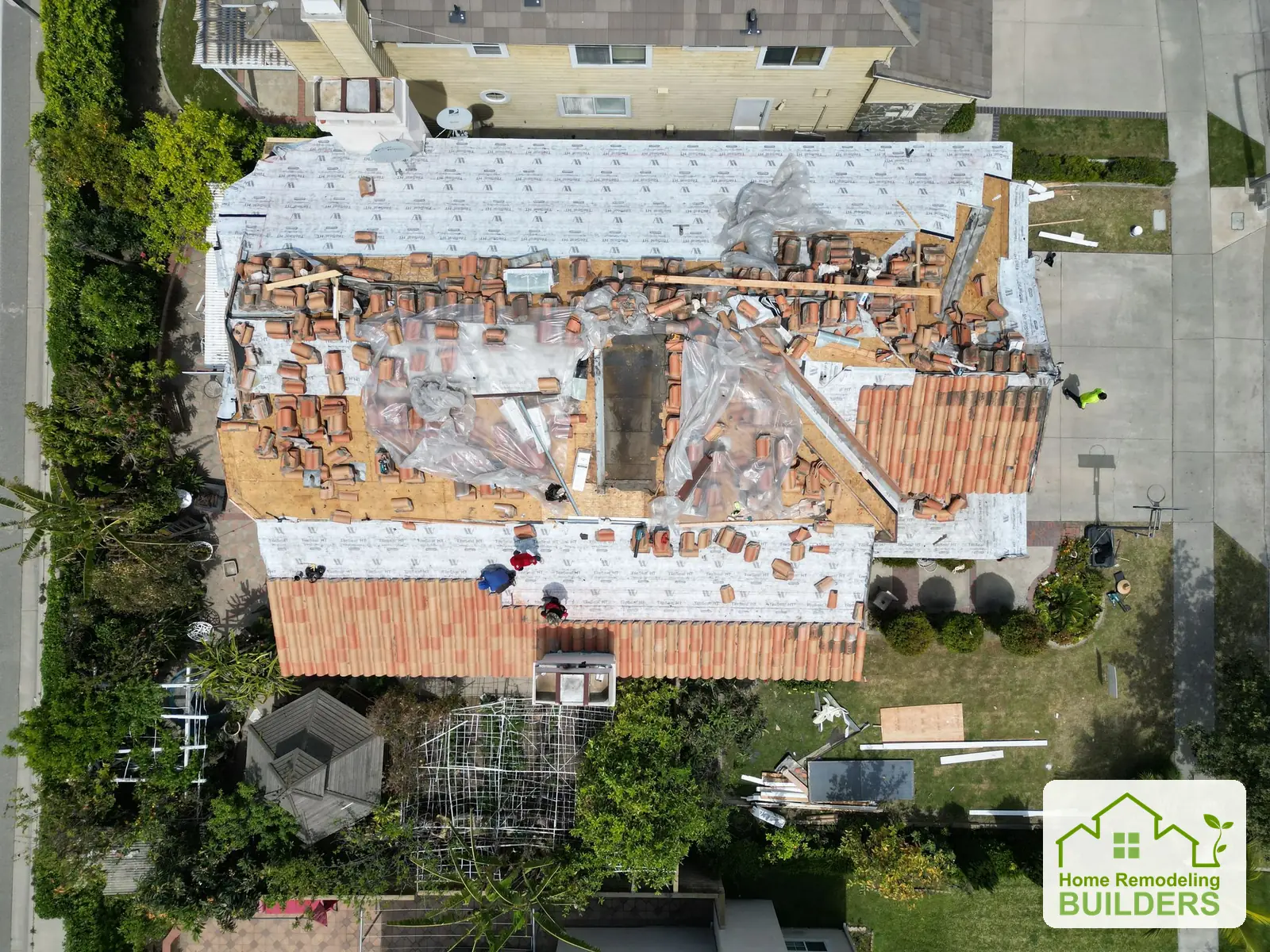 An overhead view of tile removal, exposed decking, and underlayment. Cerritos roofing project.