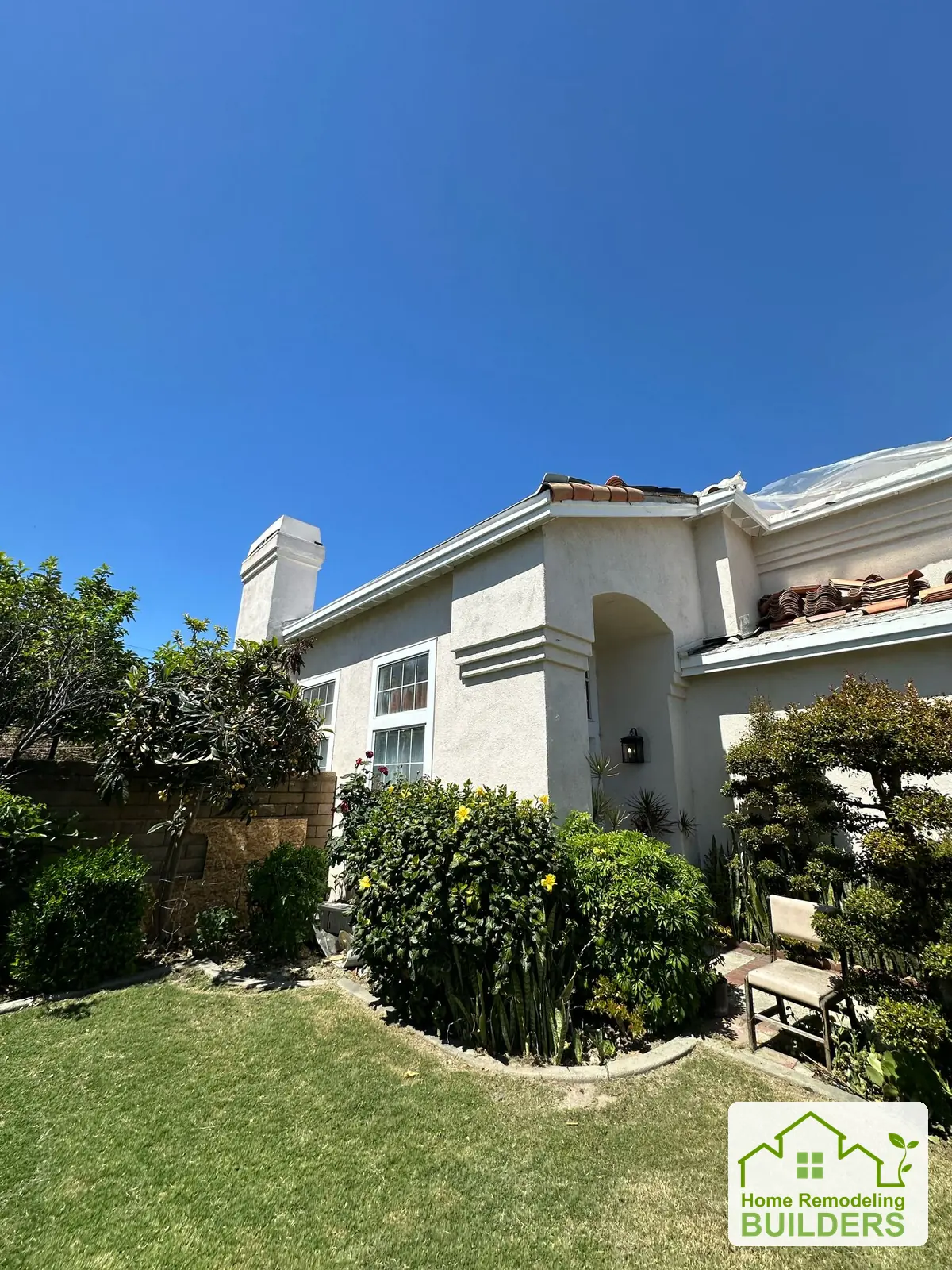 The lower roof section exposed beside the front entrance. Cerritos roofing project.