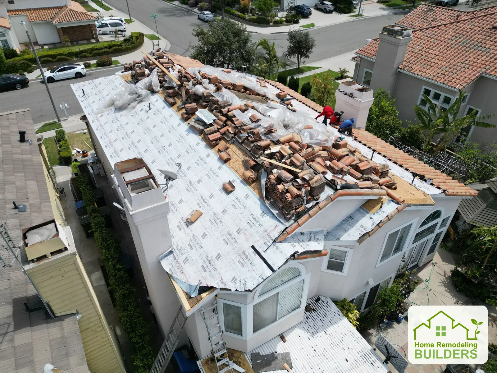 New underlayment beside carefully staged roof tiles. Cerritos roofing project.