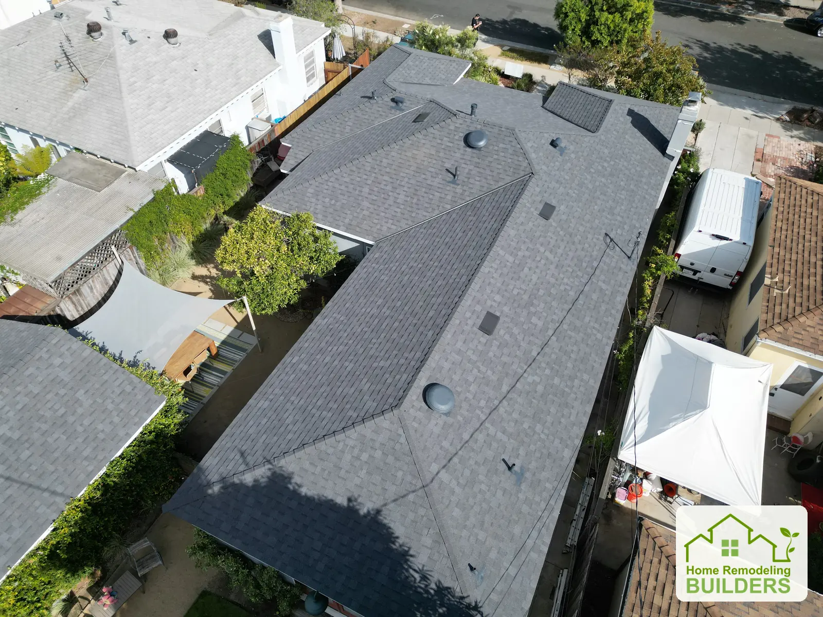 Finished shingles, ridges, and roof penetrations from above. Culver City roofing project.