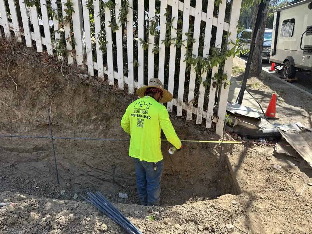Crew working in the excavation near the front of the custom home.