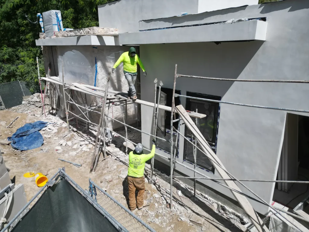 September exterior progress: crew finishing the wall from scaffolding.