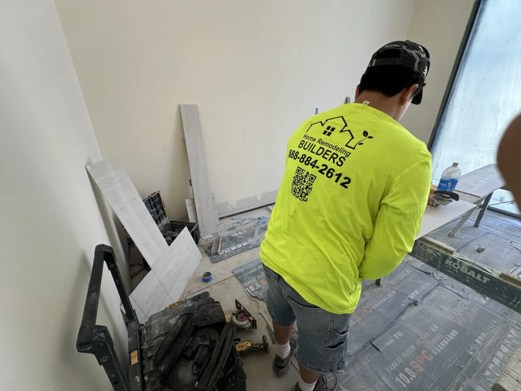 A Home Remodeling Builders crew member works at the tile cutting station.