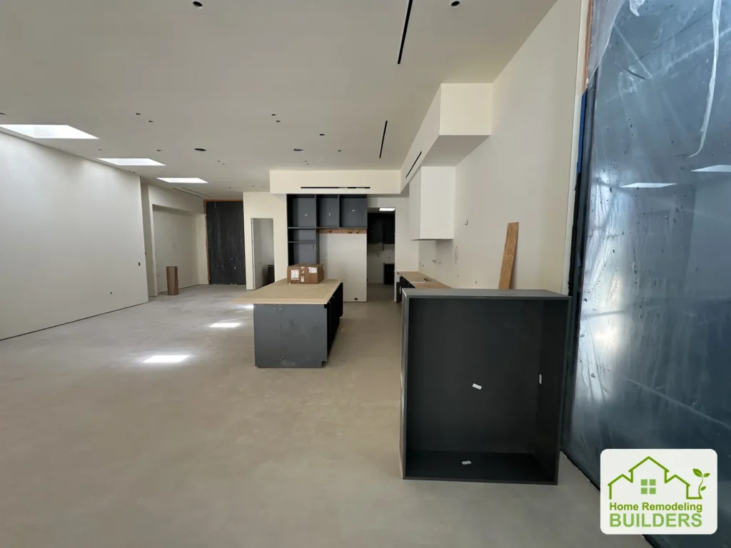 A reverse view of the kitchen and open living area during installation.