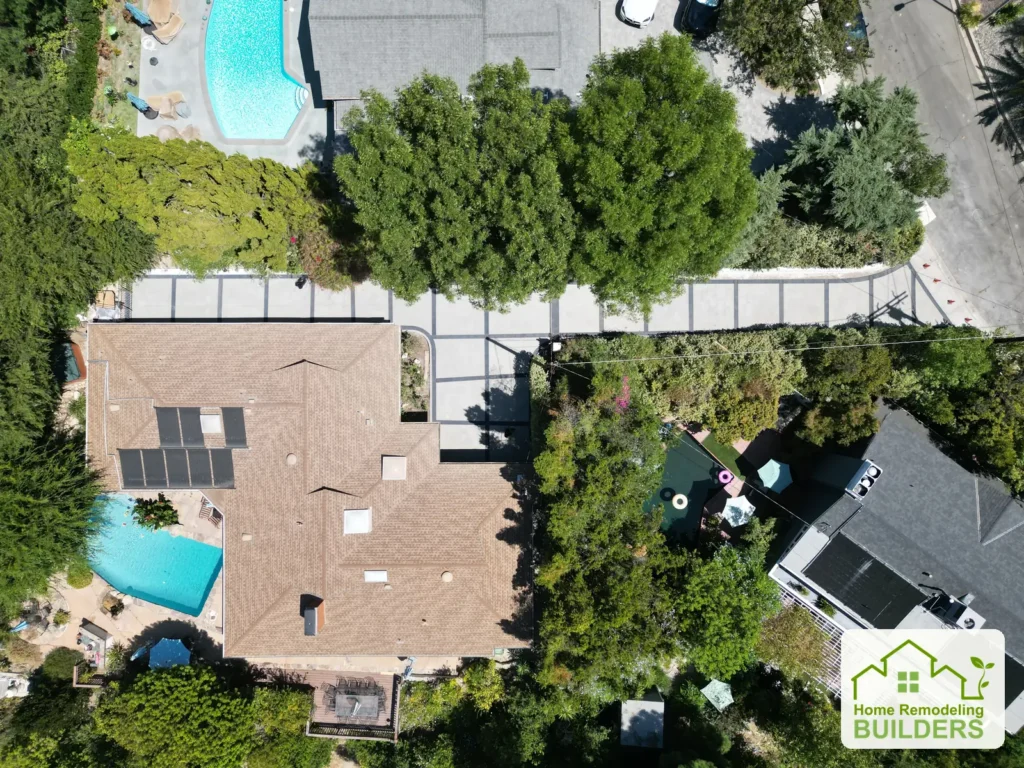 Overhead view showing the driveway through the landscaped property.