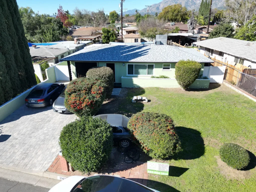 The completed Duarte roof and front elevation with the company jobsite sign.