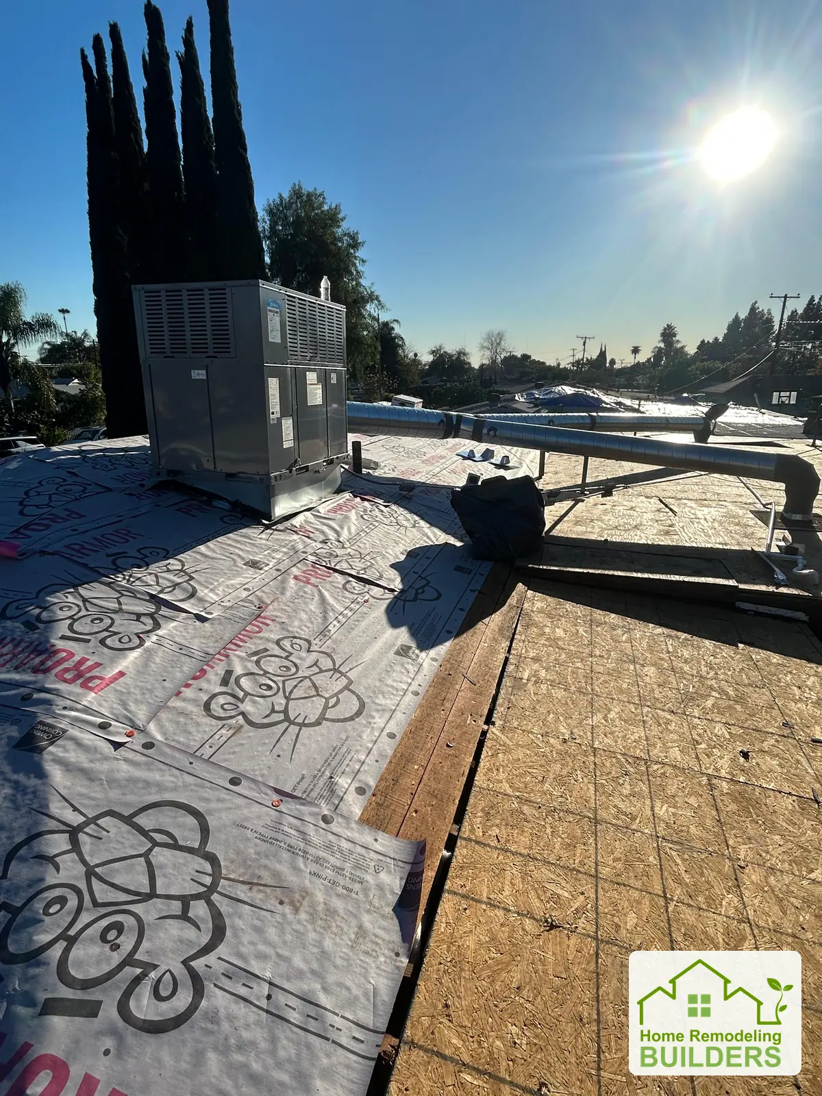 Underlayment meeting exposed sheathing beside the equipment. Duarte roofing project.