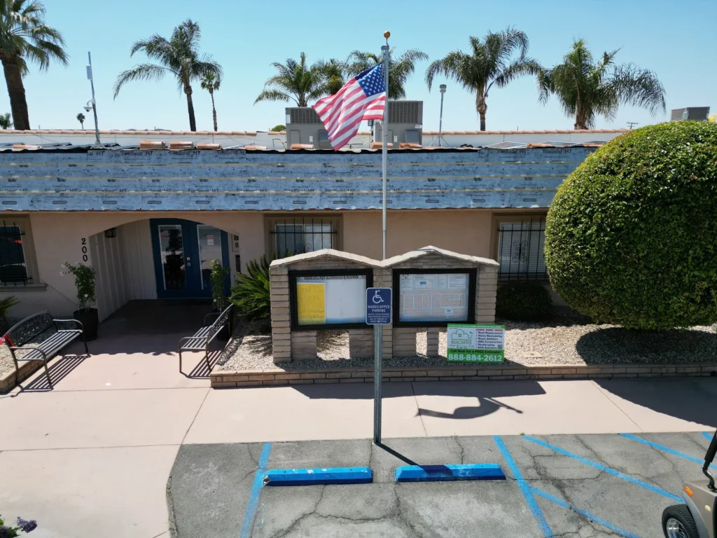 Roof Replacement Contractor Los Angeles 13 The property entrance with the company jobsite sign. Hemet roofing project.