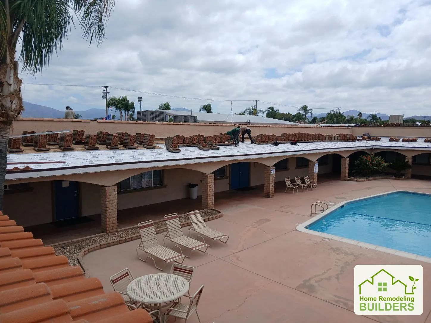 Underlayment and staged tiles above the pool courtyard. Hemet roofing project.