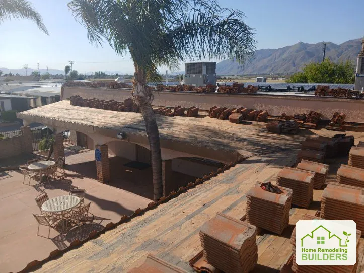 Tiles removed and stacked while the roof deck is exposed. Hemet roofing project.