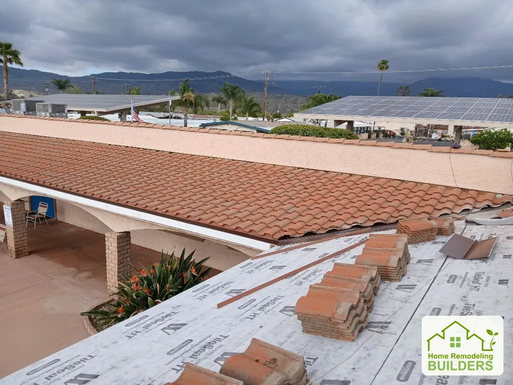 Installed tile courses meet the remaining prepared roof area. Hemet roofing project.