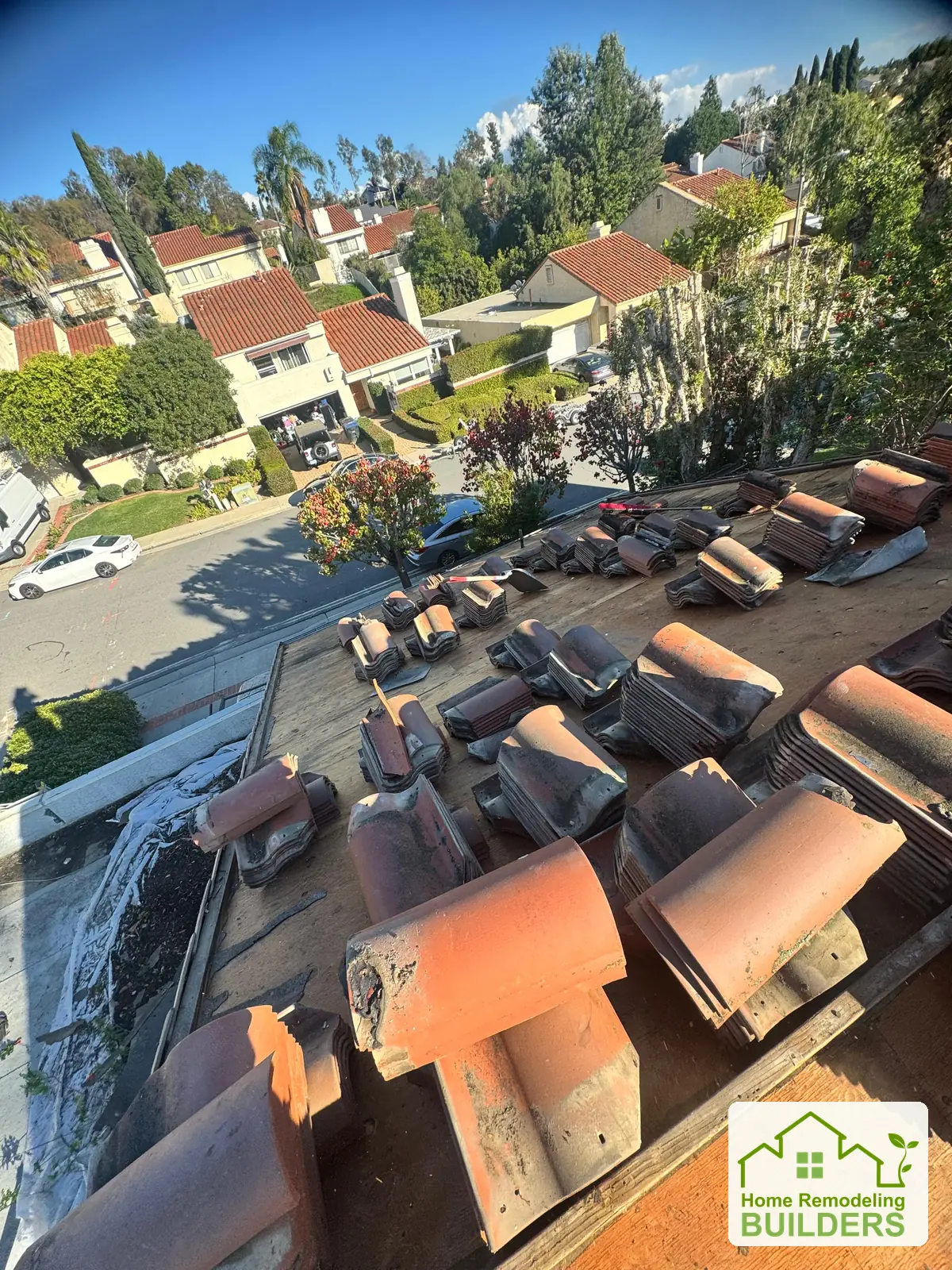 Tiles stacked beside the prepared roof area. Laguna Hills roofing project.