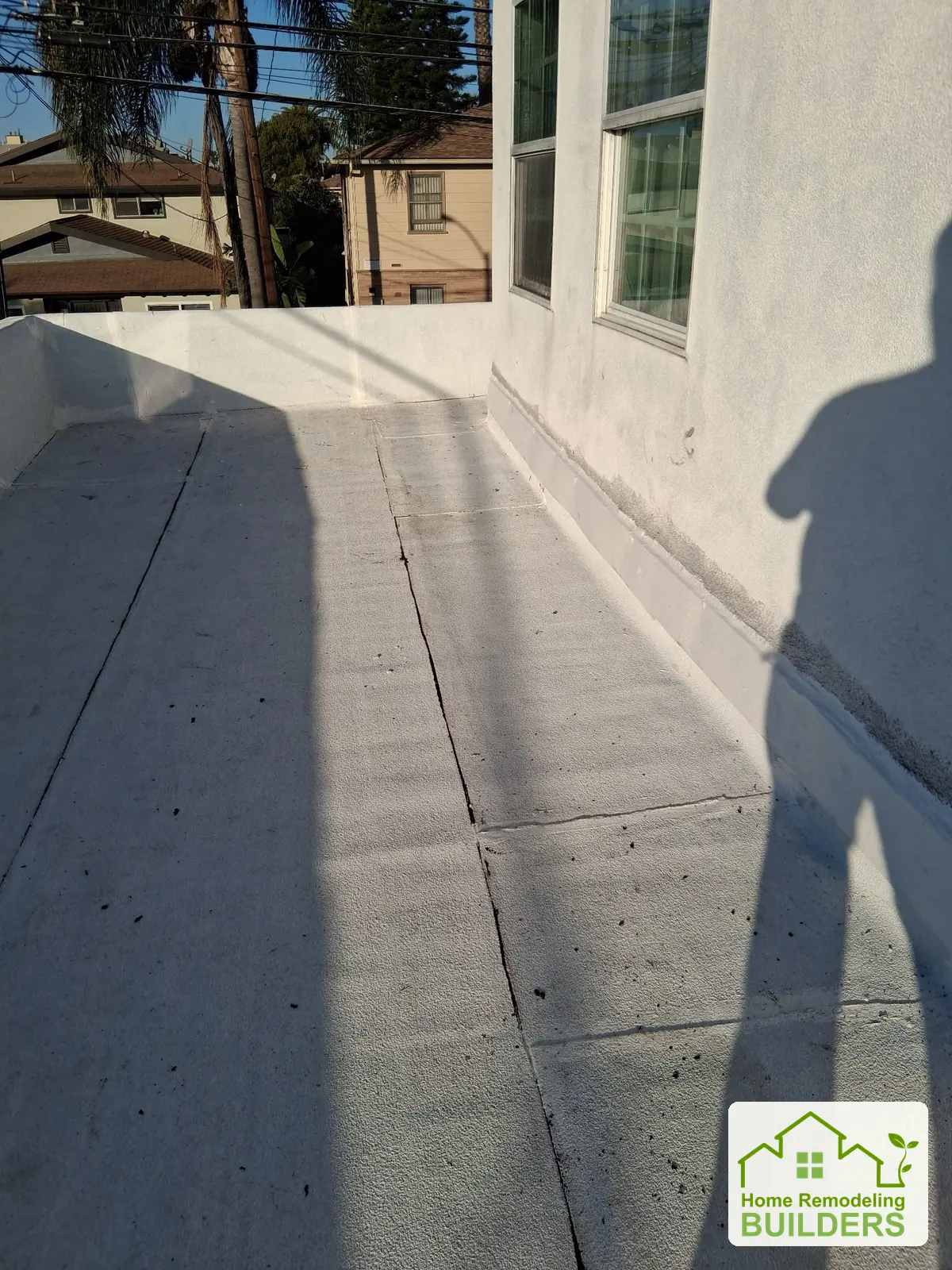 The finished roof surface beside the upper windows. Long Beach roofing project.