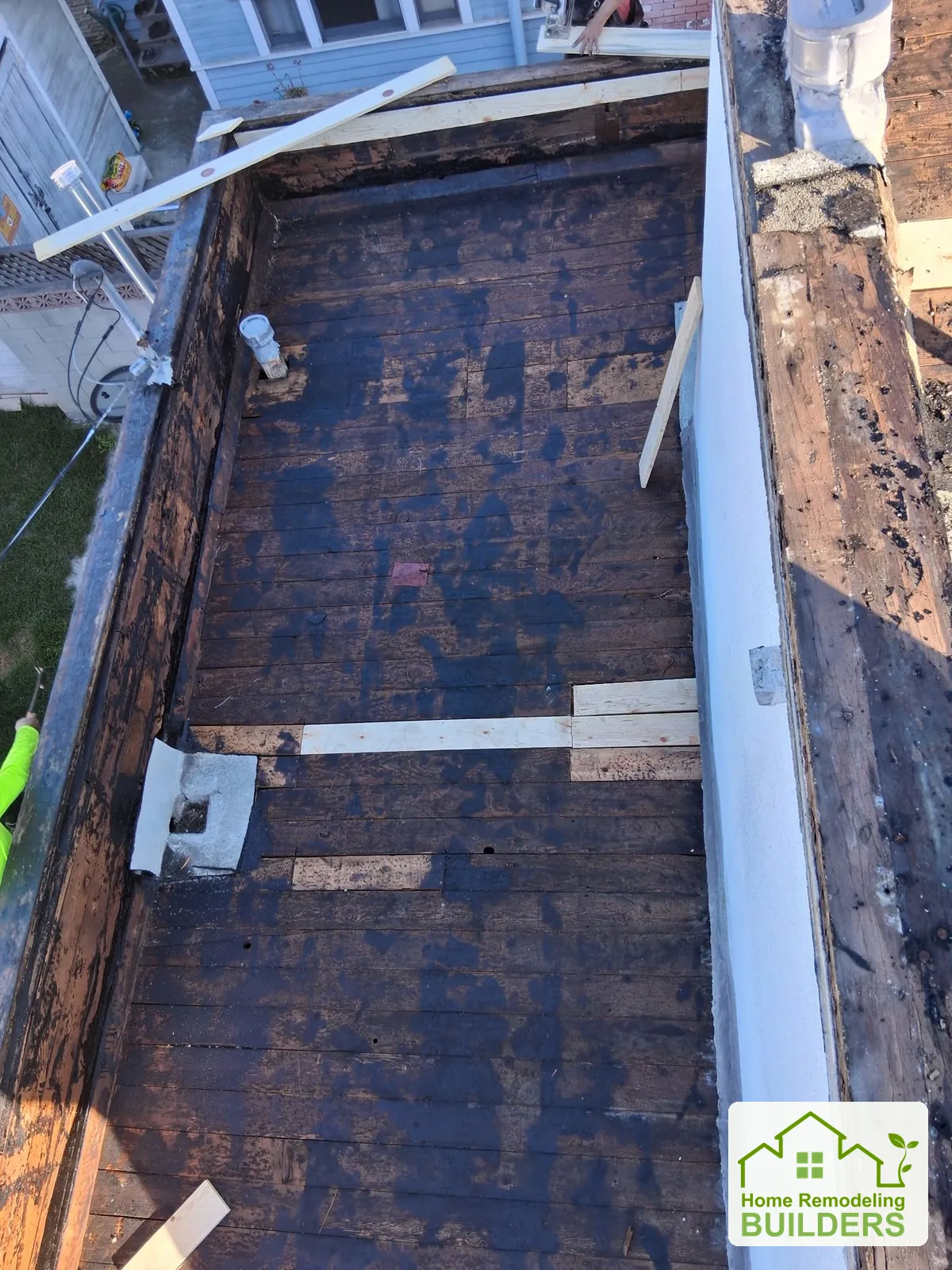 A close view of the exposed deck beside the upper wall. Long Beach roofing project.