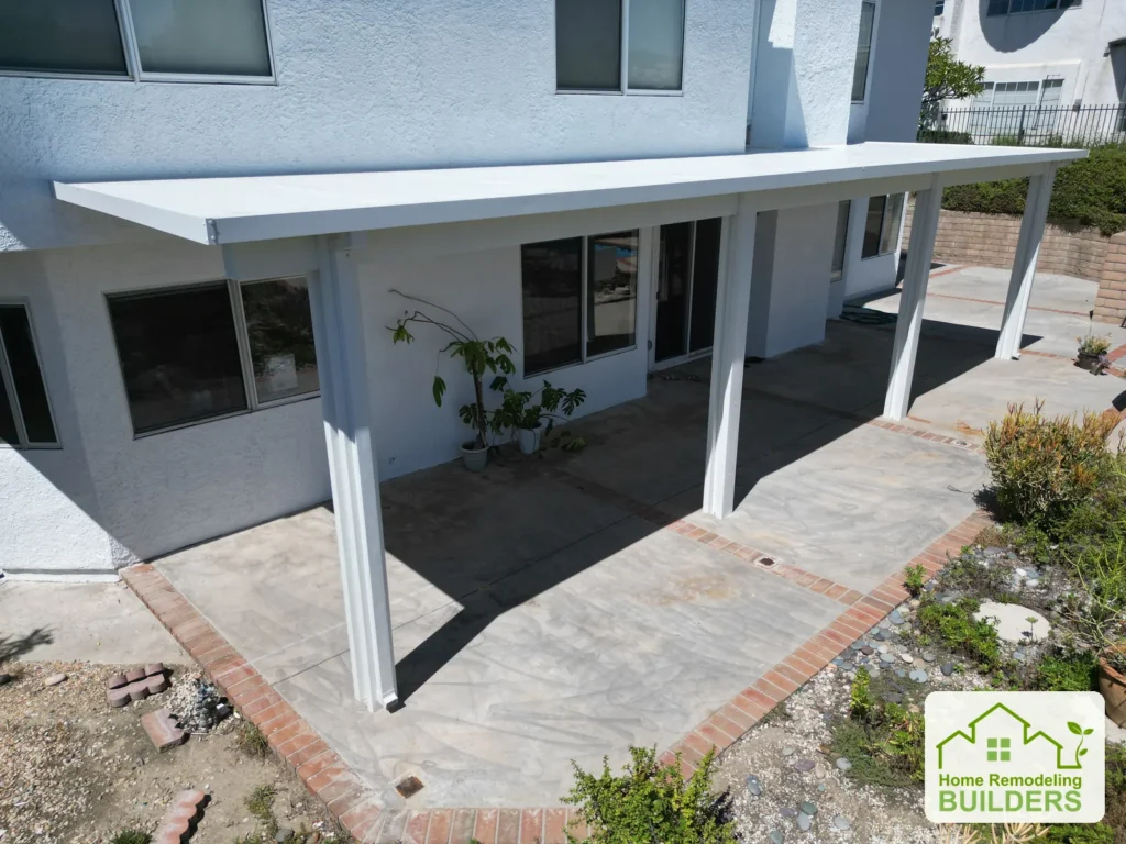 A closer look at the patio posts, shade and paved outdoor area.