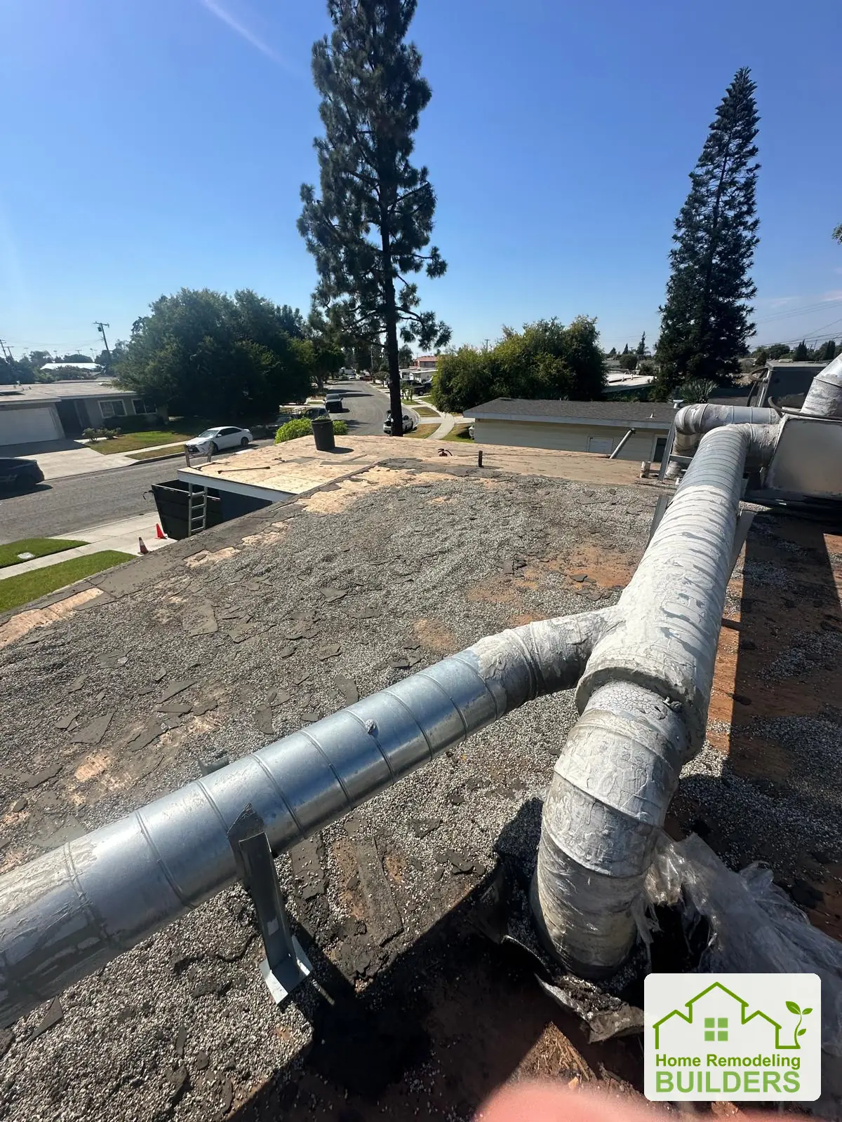 The existing roof surface beneath the ductwork. Pico Rivera roofing project.