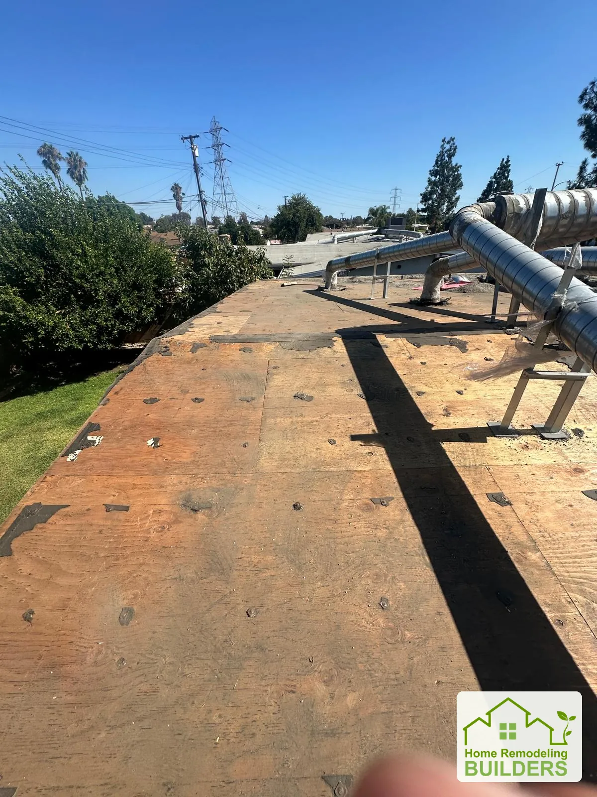 The cleared deck along the long roof edge. Pico Rivera roofing project.