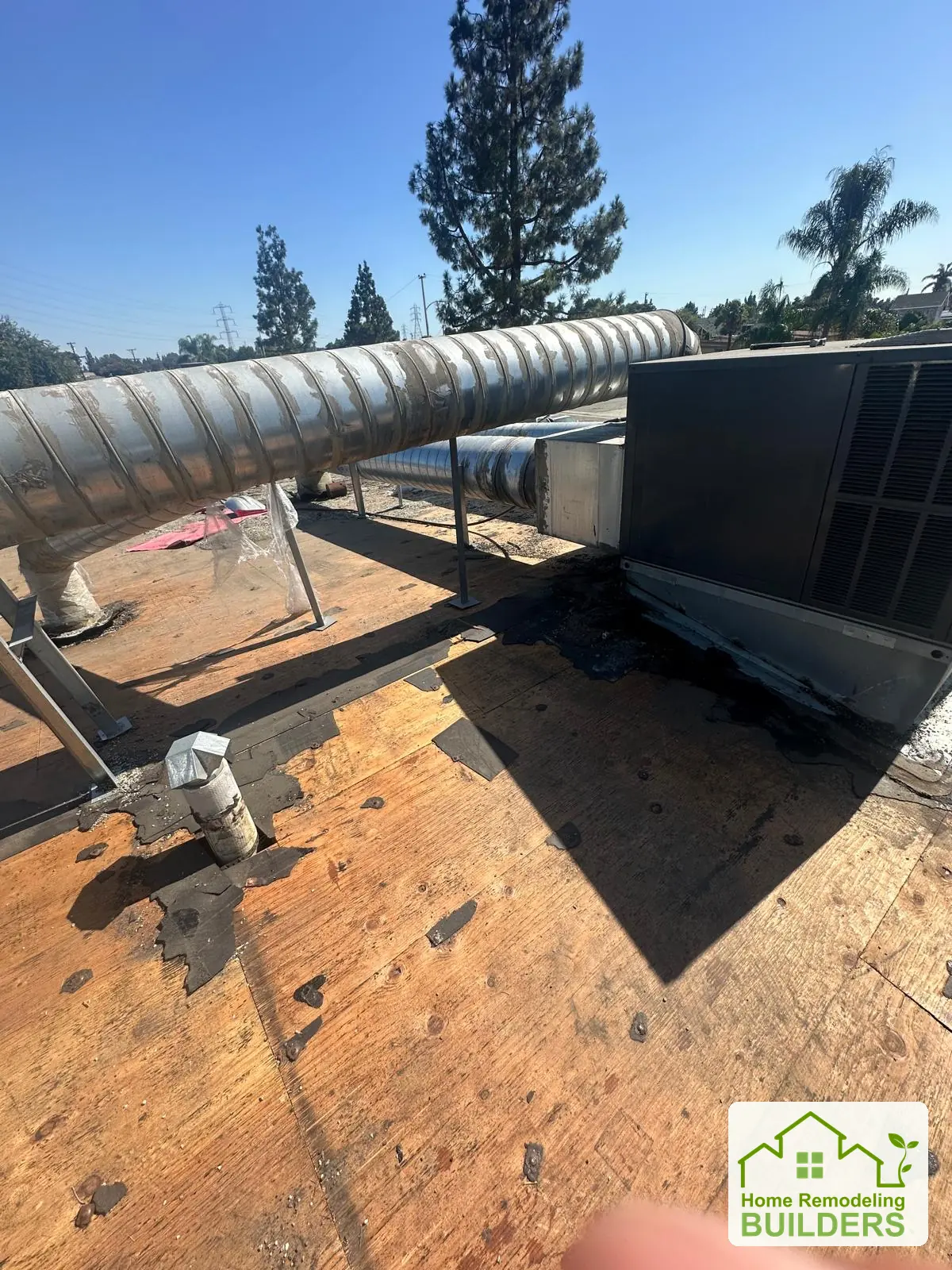 Deck preparation beside the rooftop equipment. Pico Rivera roofing project.