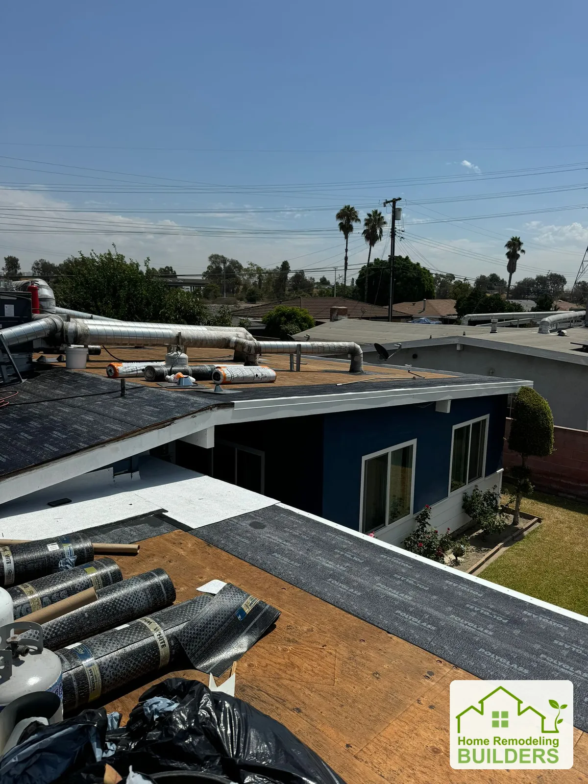Roofing materials staged beside the prepared area. Pico Rivera roofing project.