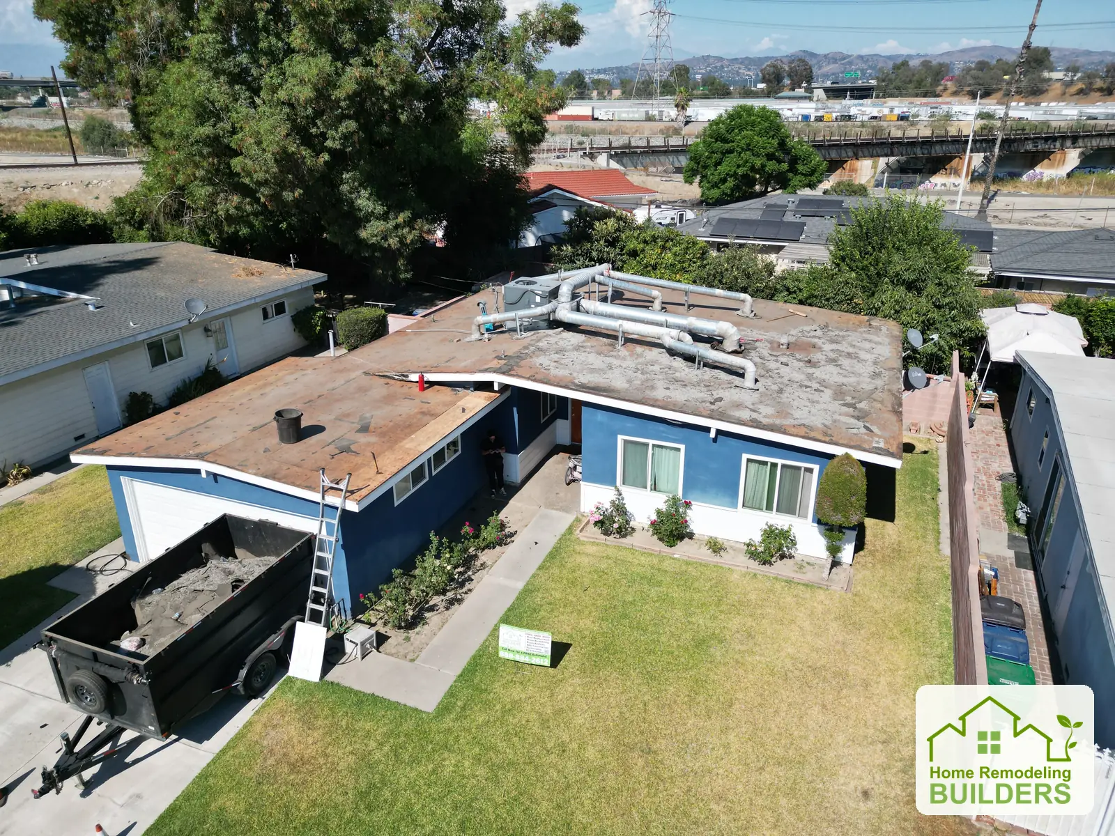 Roof removal viewed from above the backyard. Pico Rivera roofing project.