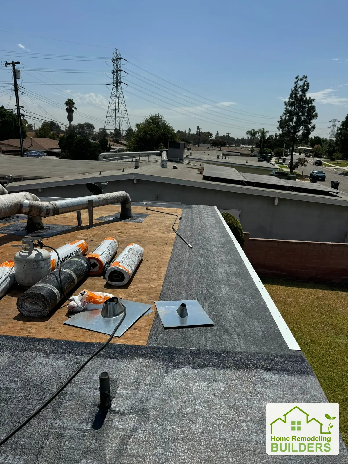 Roofing installation advancing across the prepared deck. Pico Rivera roofing project.