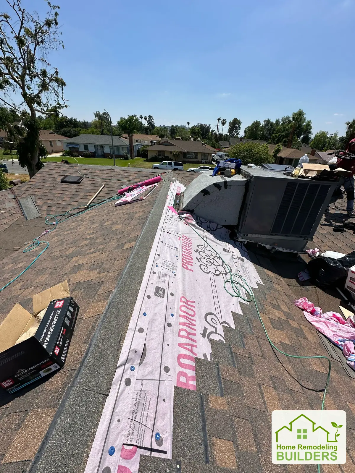 Underlayment and new shingles meeting along the ridge. Riverside roofing project.