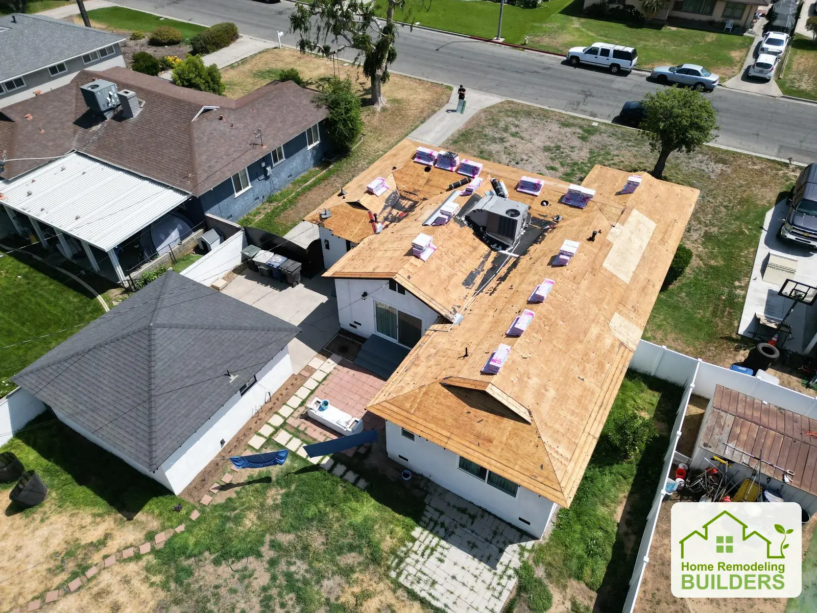 The newly sheathed roof with materials staged for installation. Riverside roofing project.