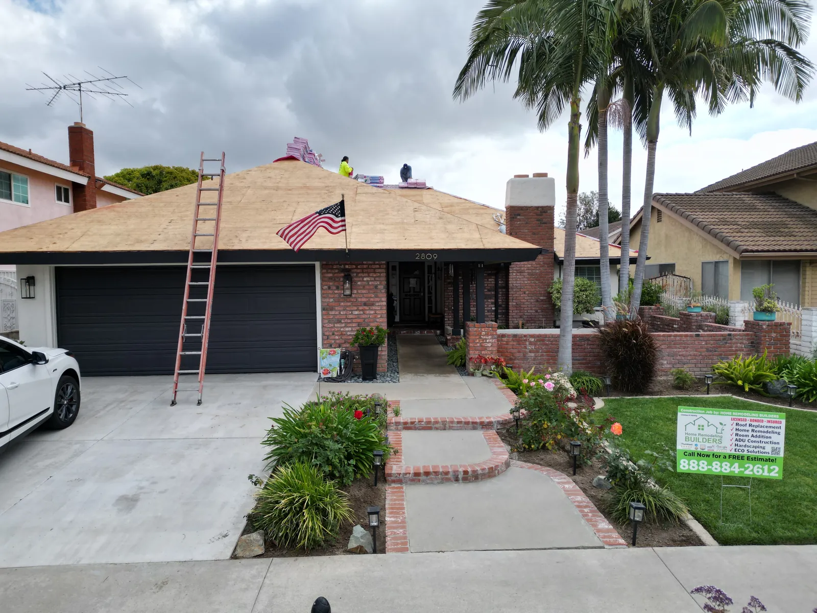 The crew working above the newly sheathed front roof. Santa Ana roofing project.