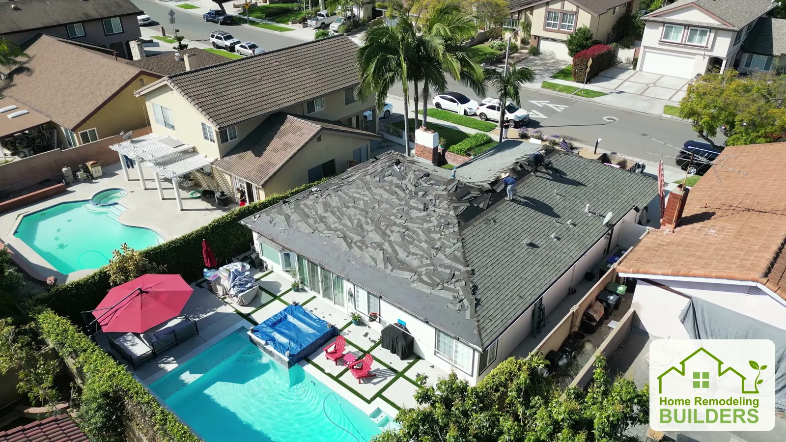 The roofing crew removes the old covering across the front roof slopes. Santa Ana roofing project.