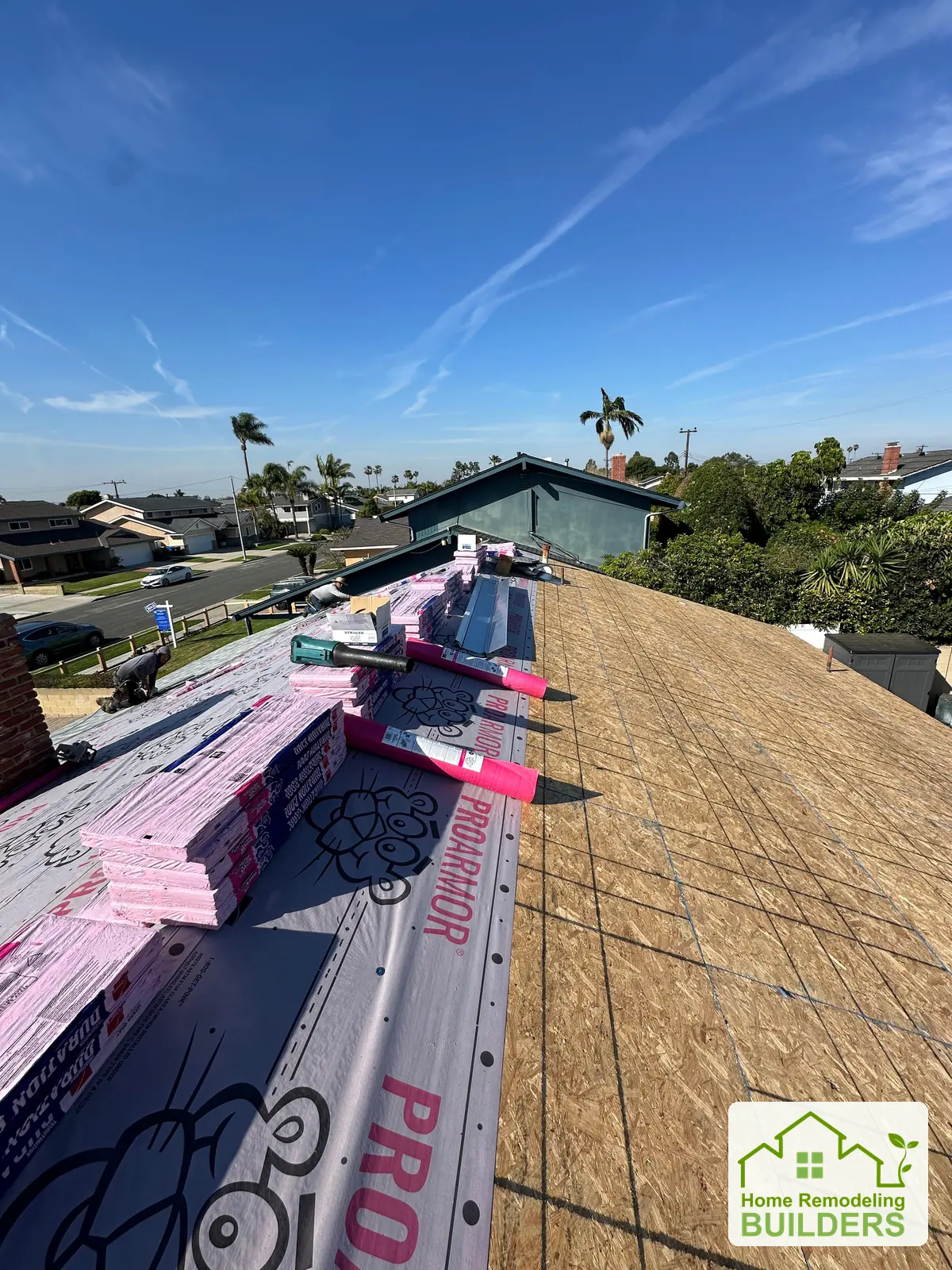 Underlayment and roofing bundles beside the new sheathing. Westminster roofing project.