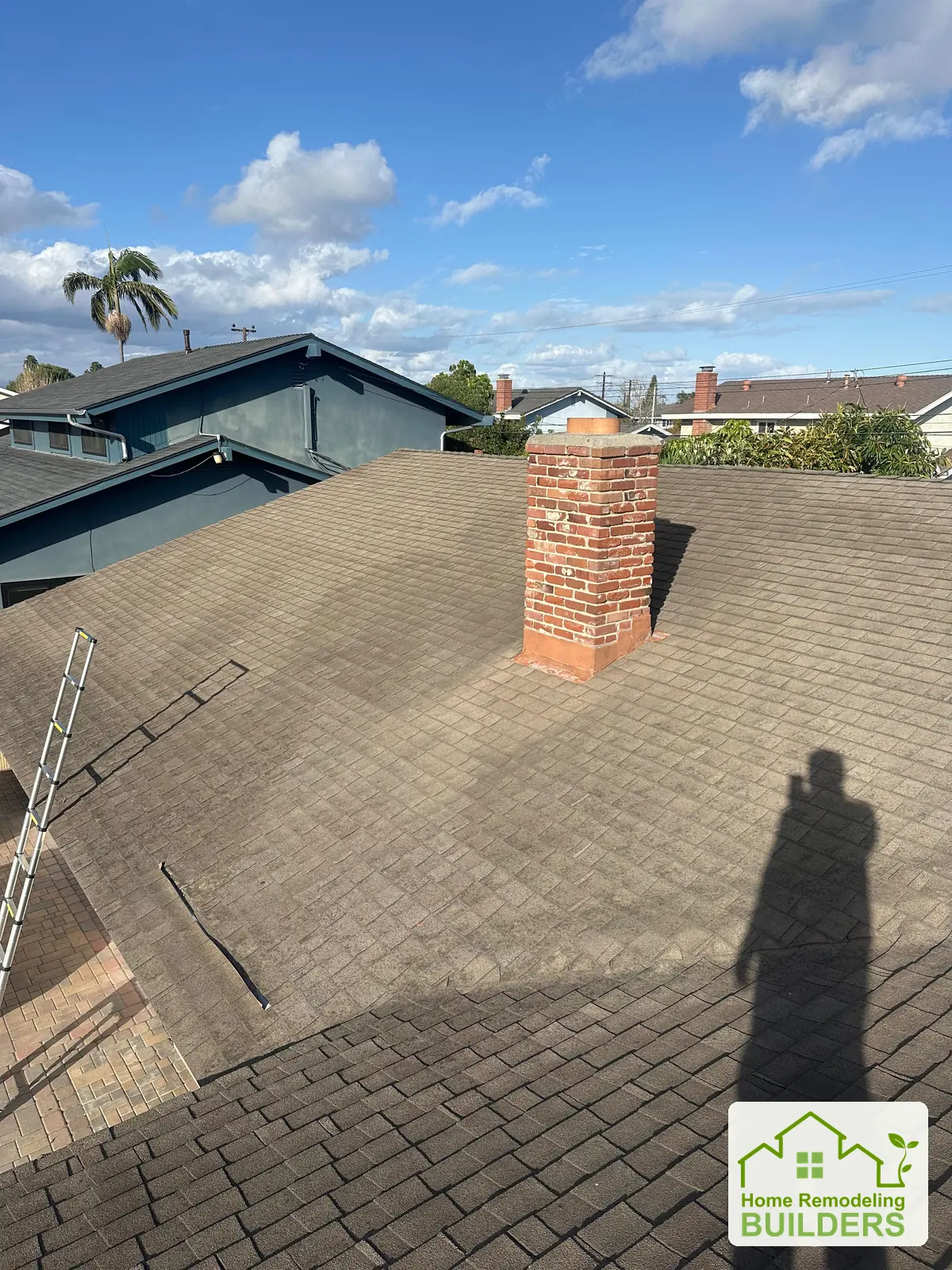 The original roof around the brick chimney. Westminster roofing project.