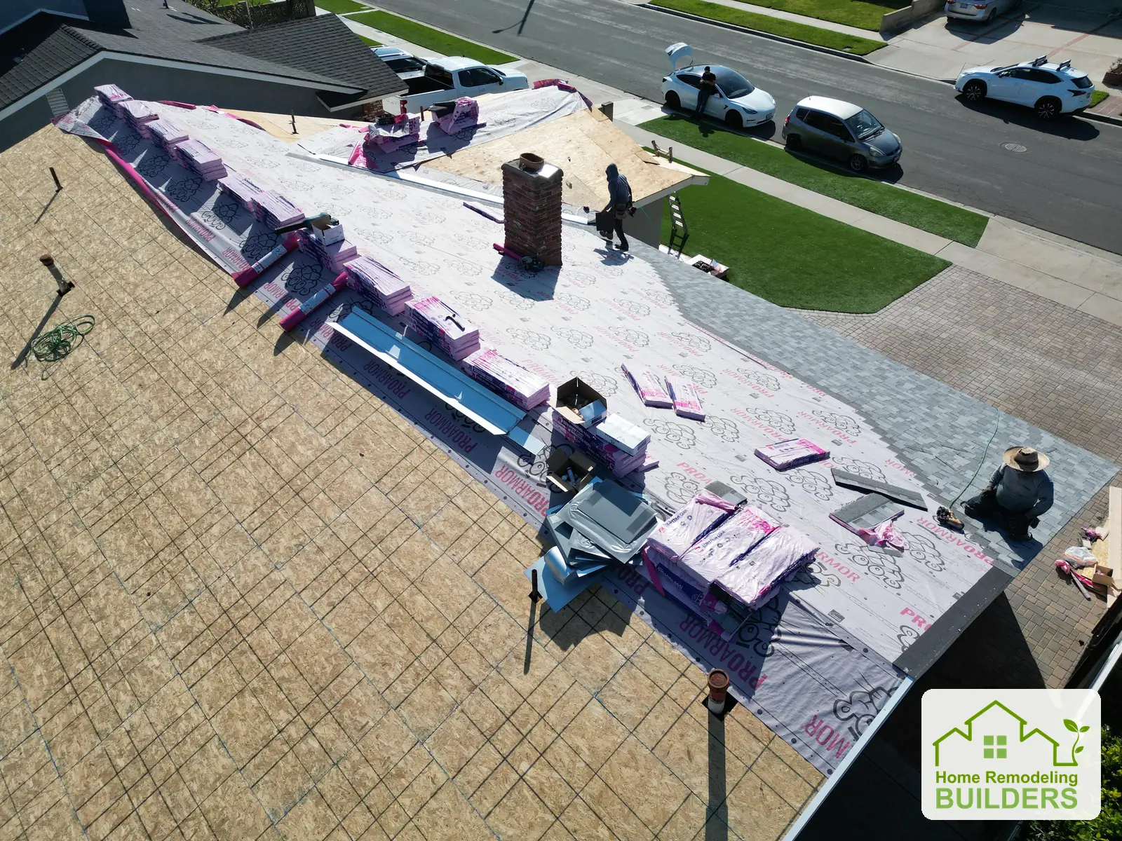 The crew working along the prepared roof ridge. Westminster roofing project.