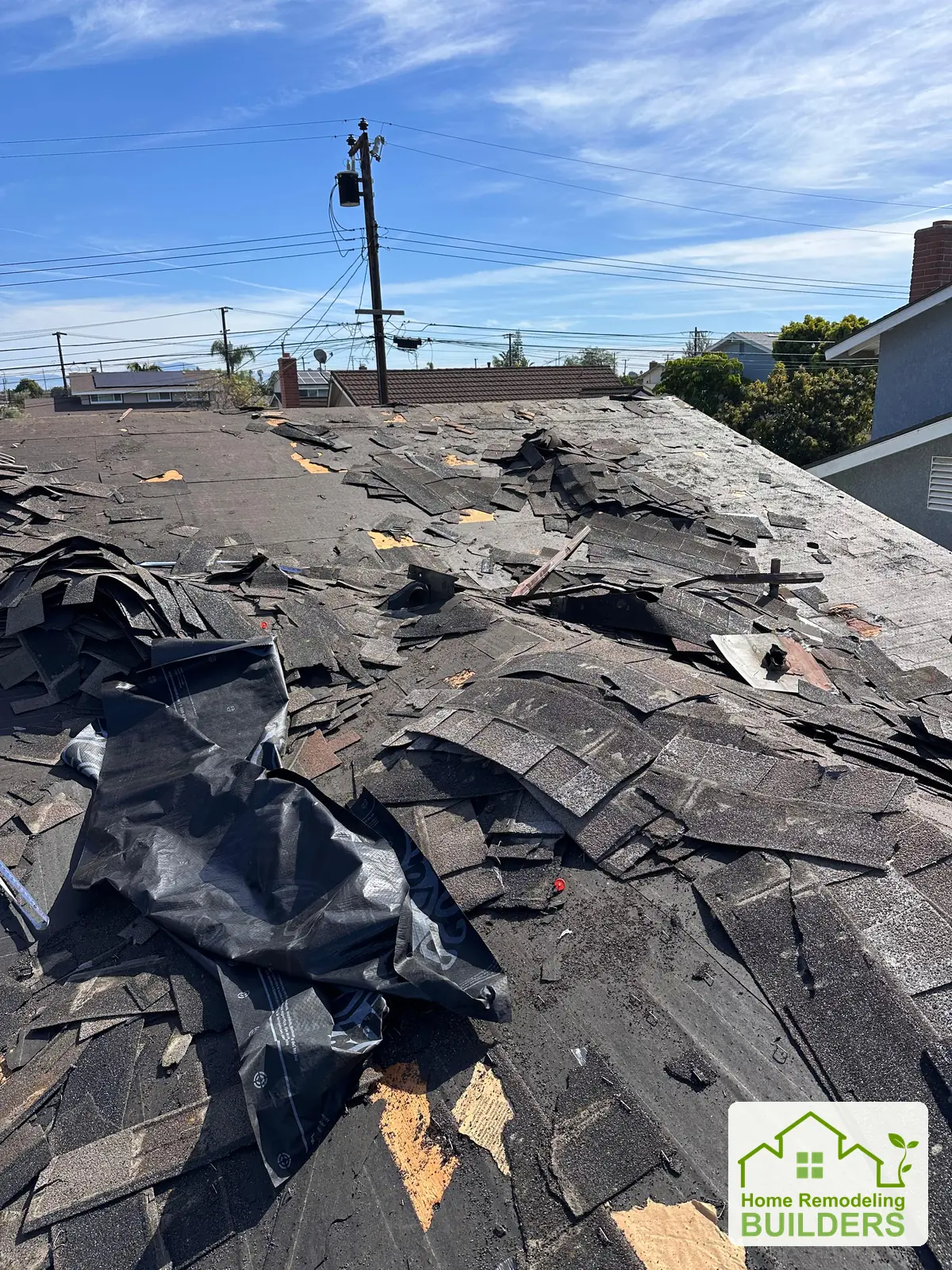 Shingle removal across the existing roof surface. Westminster roofing project.